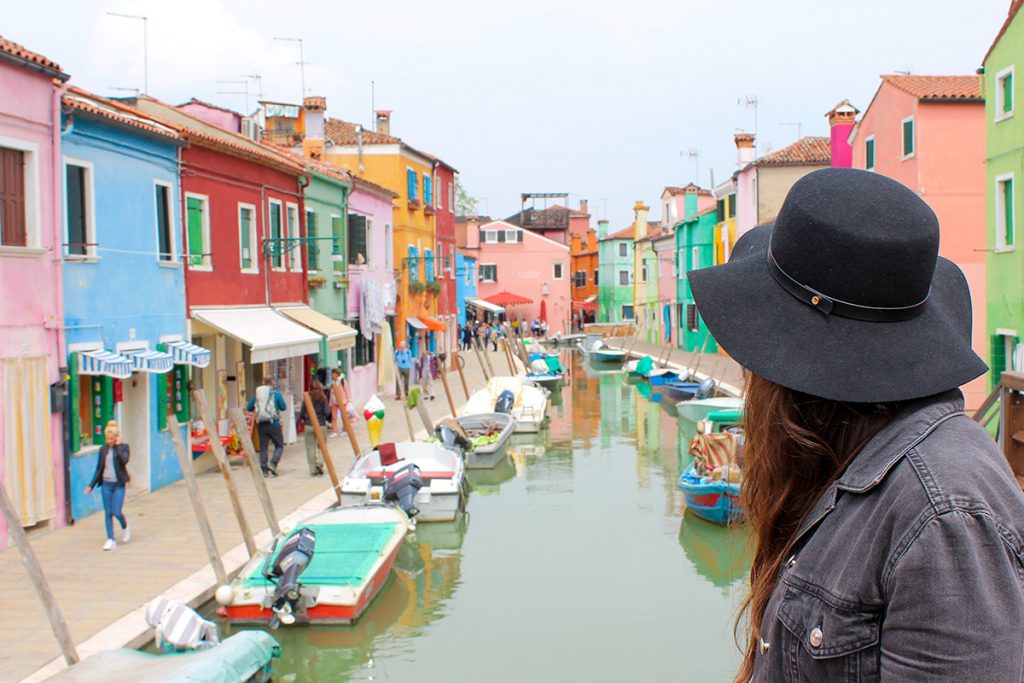 girl overlooking the the colourful town of burano