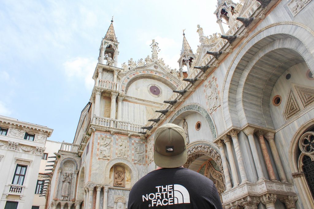 guy looking up at the exterior of saint marks basilica