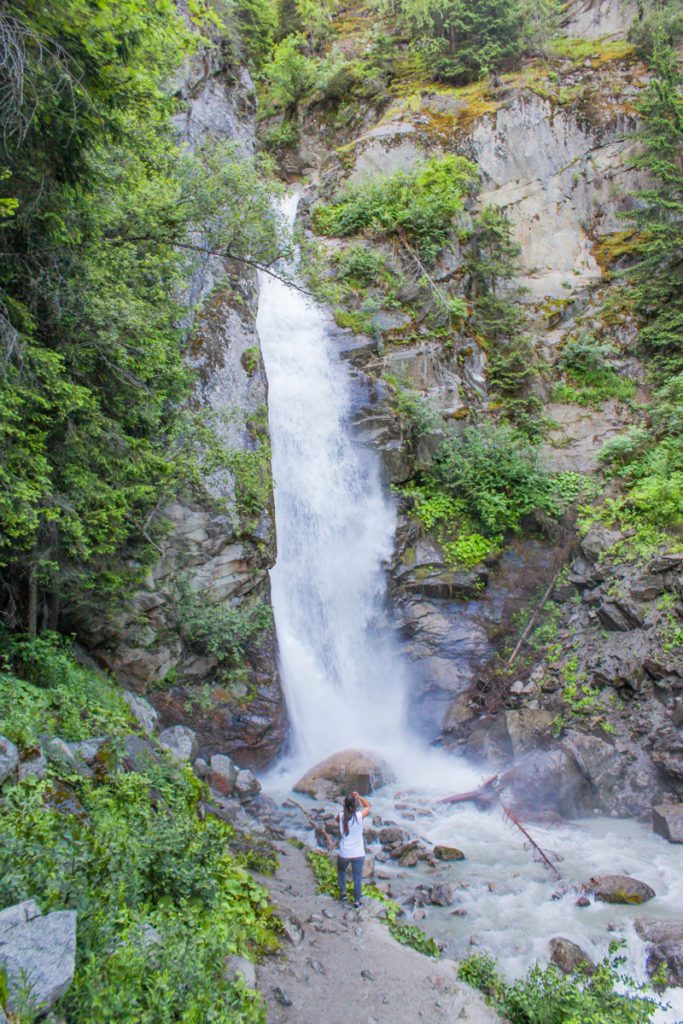 girl standing in front of cascade du dard