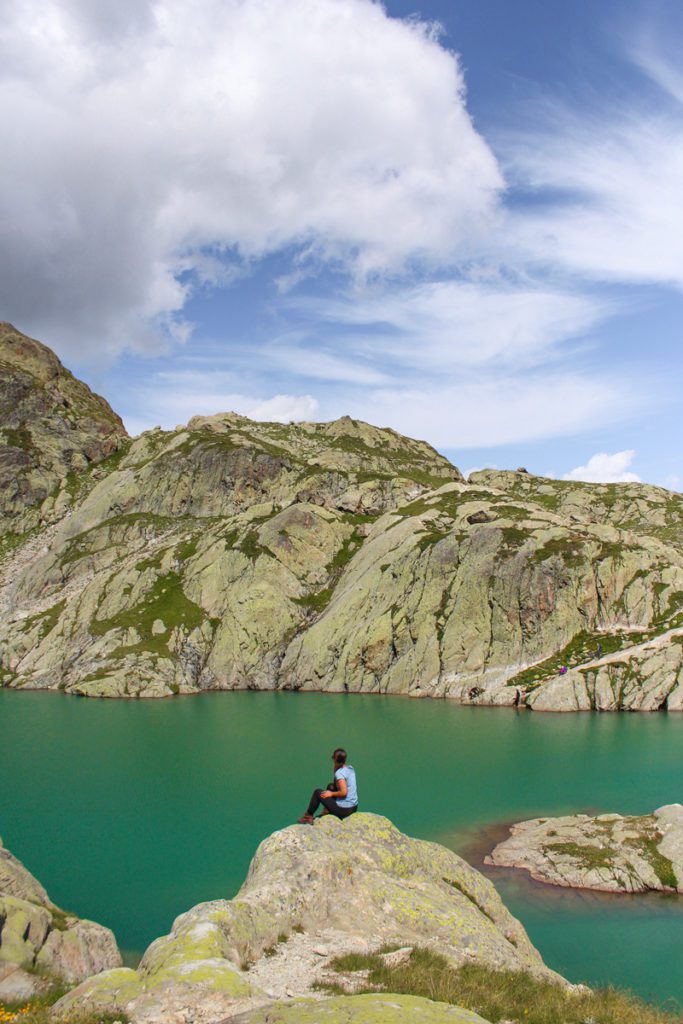 girl sitting on the edge of a mountain overlooking lac blanc