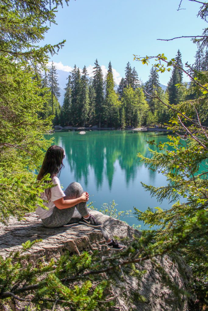 girl sitting on a rock overlooking lac vert