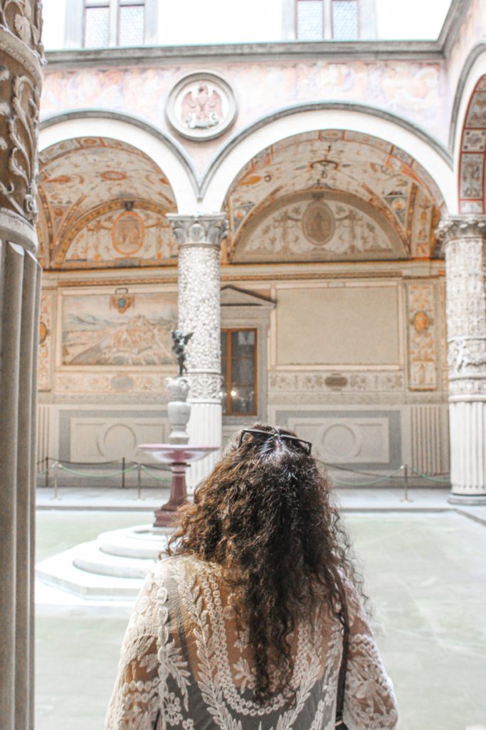 woman standing in some florence architecture