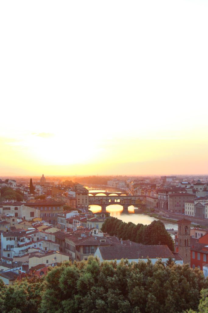 view of the arno river and florence at sunset