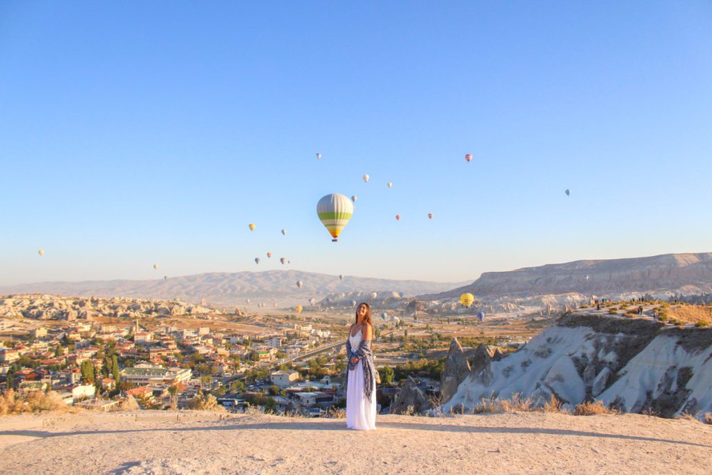 girl standing on lovers hill at sunrise